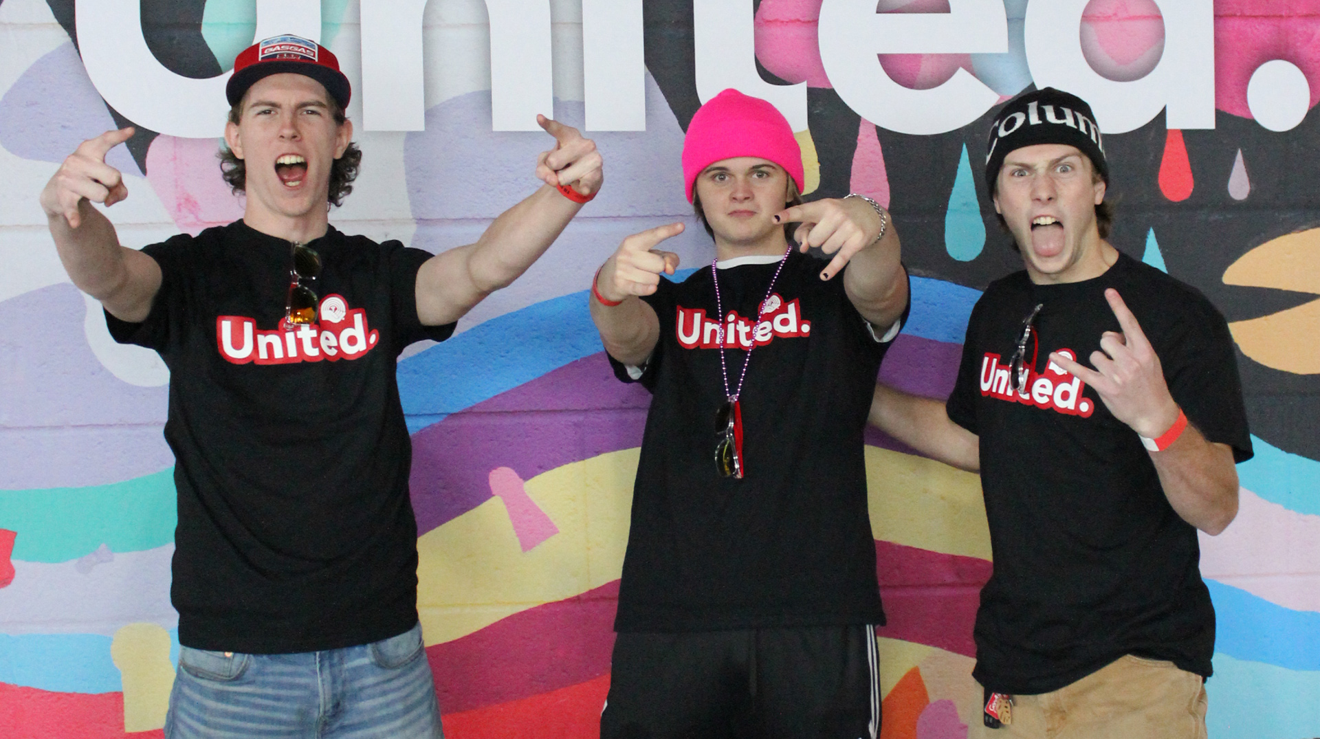 Left to right: Max, vocalist and lead guitarist is wearing red ballcap, jeans; Kaelin, drummer is blonde with a pink toque and Adidas pants; Evan, basist is wearing a Columbia toque and khaki pants.