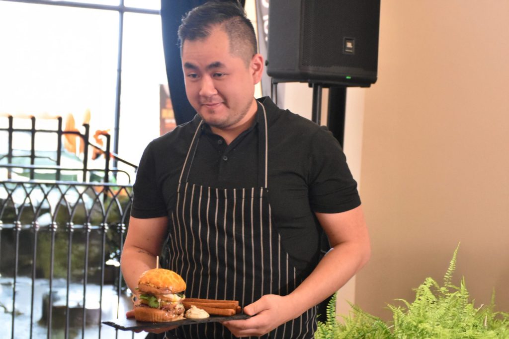 Chef Joe, from Cintro on Wellington, holding his burger creation for Ultimate Burger Battle