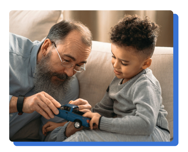 Legacy giving, grandfather and grandson play with toy truck
