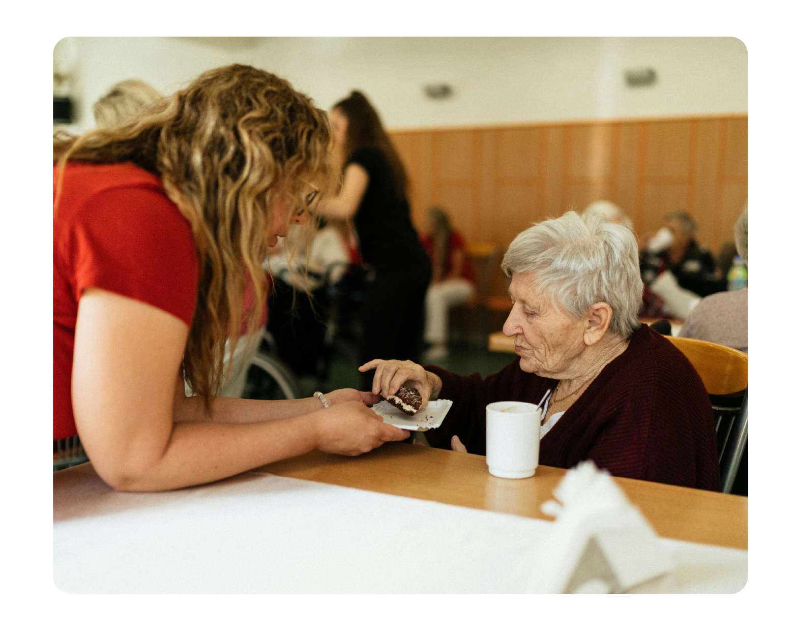 Women United, woman helping older woman.